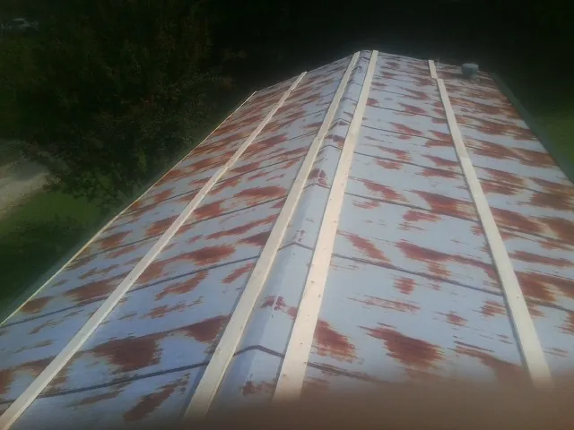 Rusted metal roof panels with new wood purlins before replacement — Storm Damage Roof Repair in Wadmalaw Island by Roofing Brothers