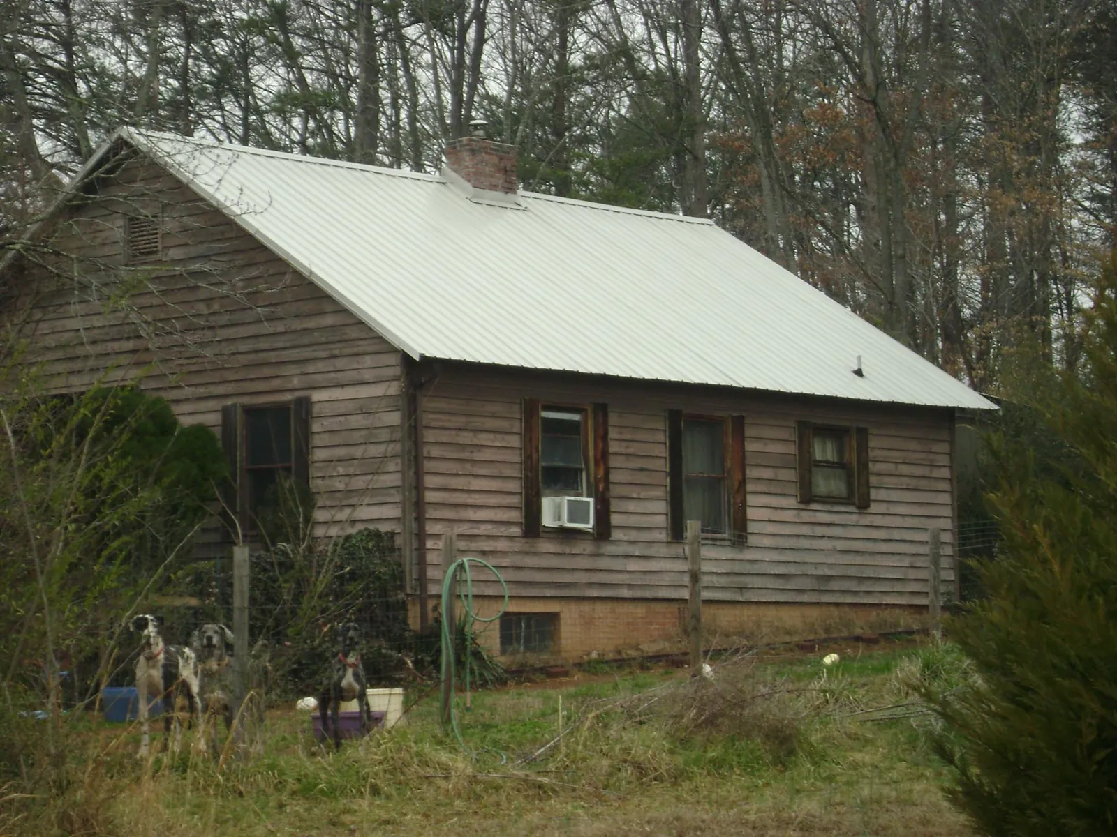 White metal roof on an old wood sided farmhouse, from a Metal Roof Installation job in Wadmalaw Island
